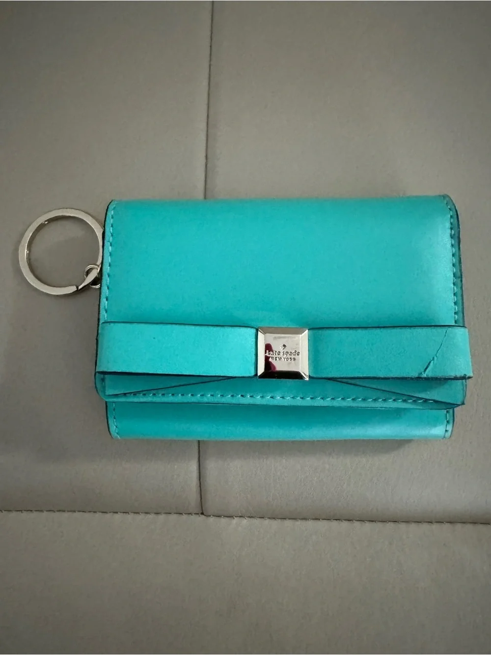 kate spade turquoise wristlet with gold logo